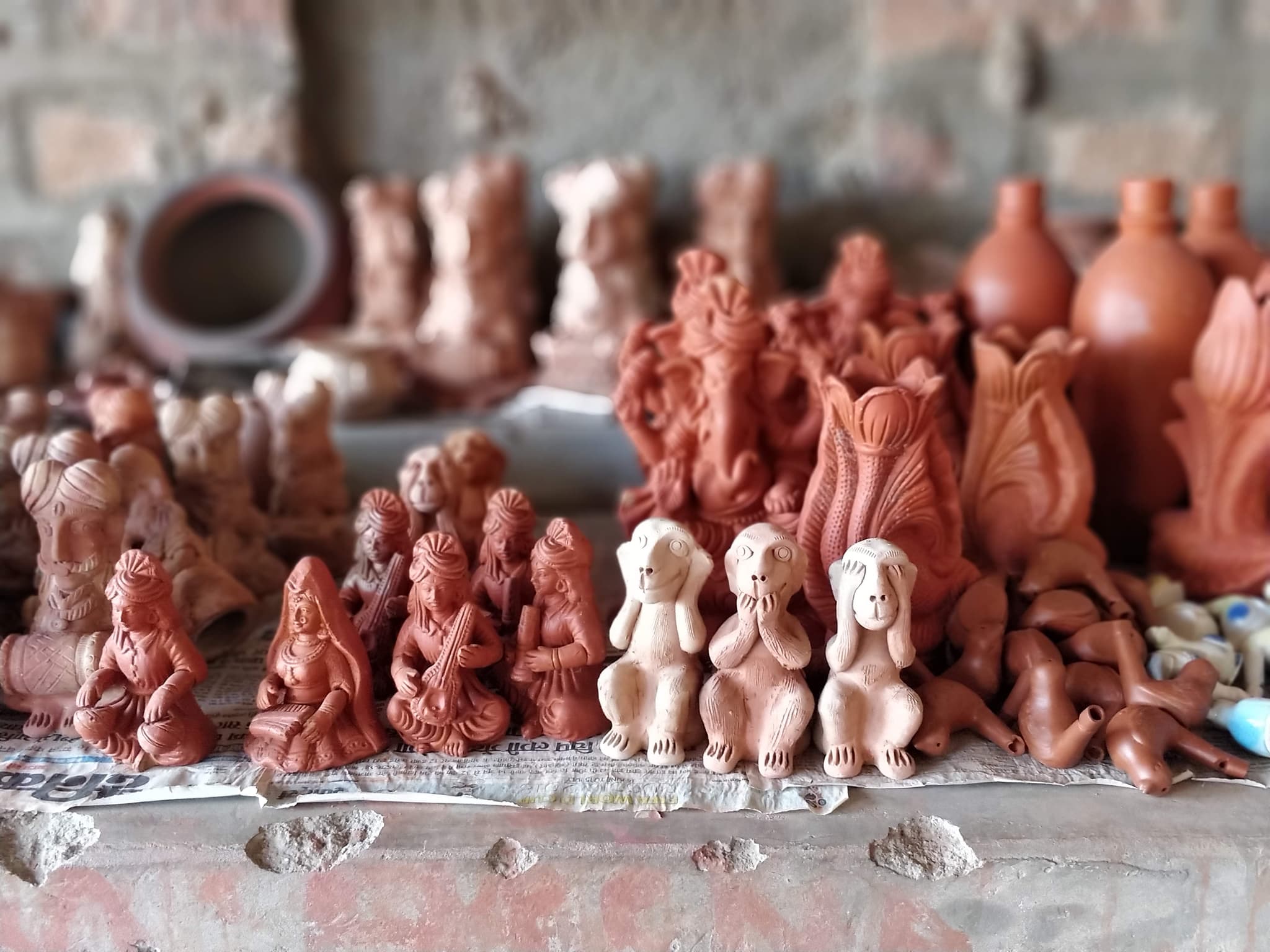 Terracotta figurines including Ganesh idols with beautifully blurred background