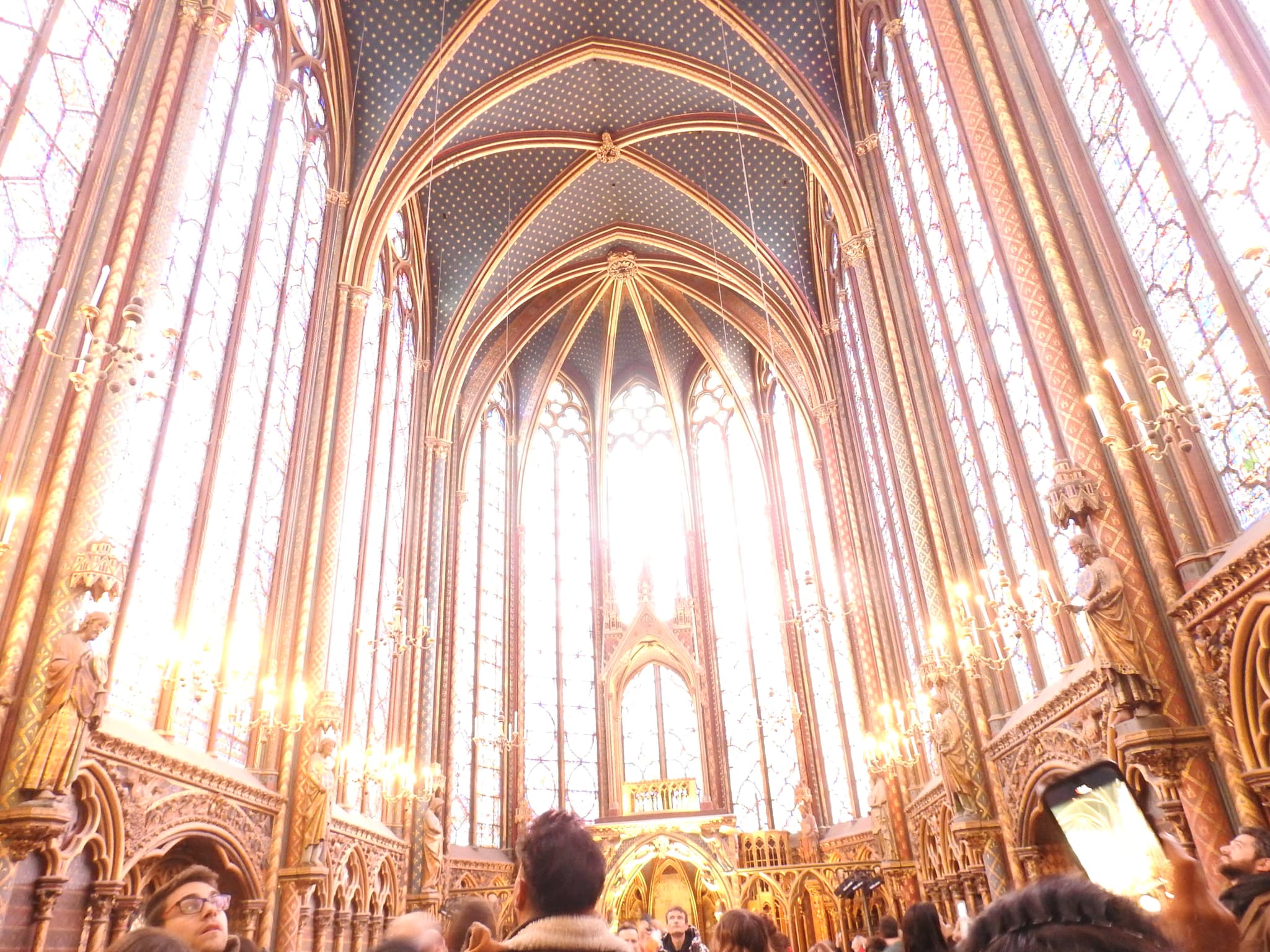 The soaring interior of Sainte-Chapelle with light streaming through stained glass